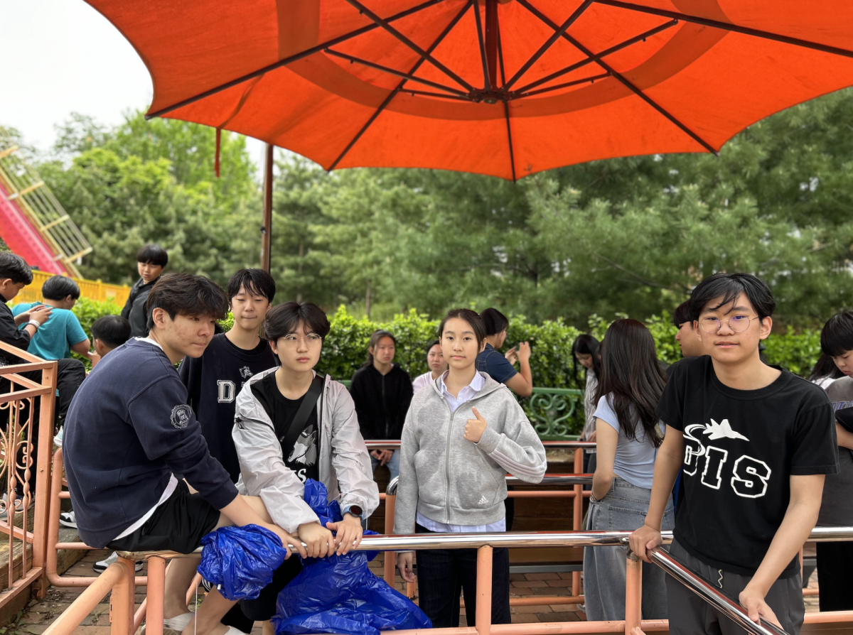 Claire Kim and company line up to ride the 360 swing, drenched in water by the flume ride.